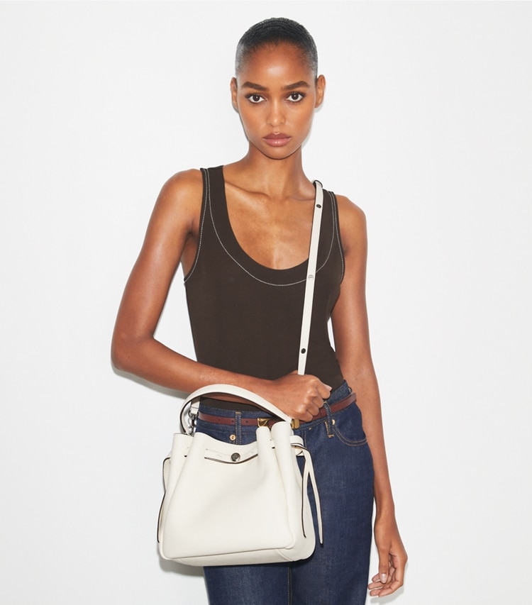 Tory Burch designer crossbody bags Romy Bucket Bag in Light Cream accessory on model