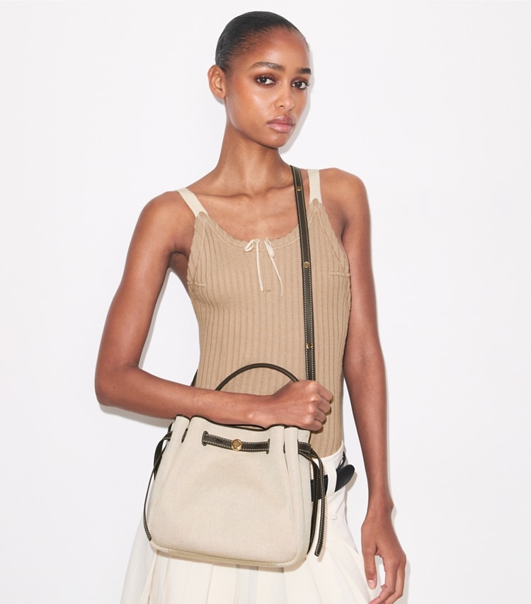 Tory Burch designer crossbody bags Romy Canvas Bucket Bag in Dusty Almond/ Bianco White additional on model