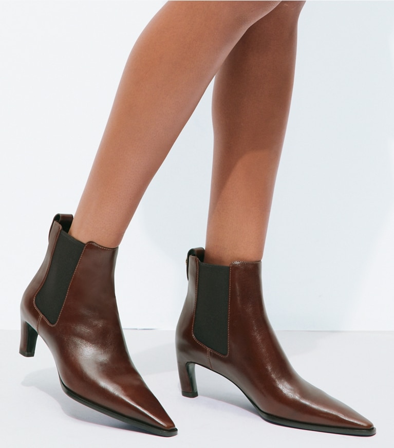 Tory Burch designer ankle boots Romy Chelsea Boot in NEGRONI accessory on model