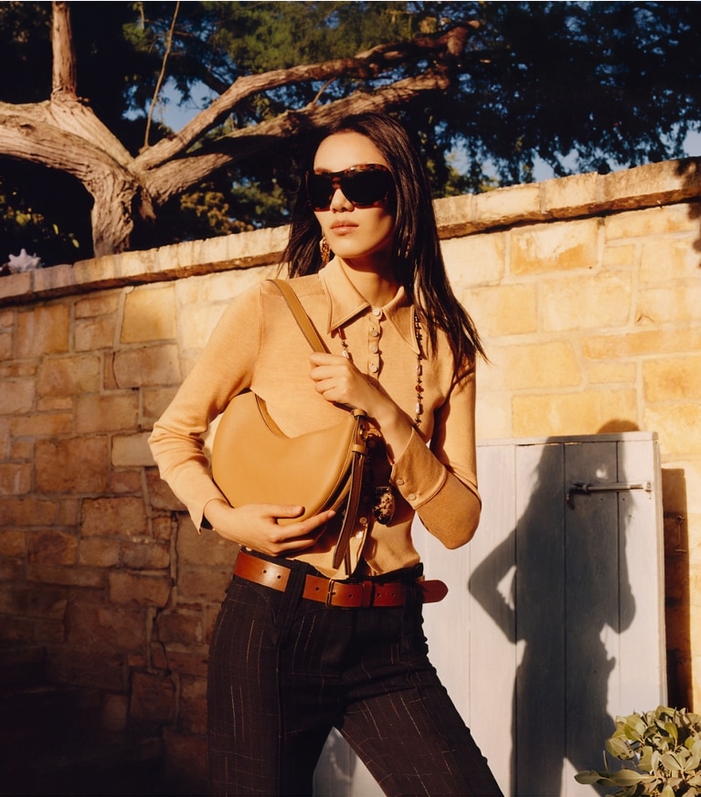 Tory Burch designer shoulder bags Romy Half Moon Bag in Tiramisu campaign