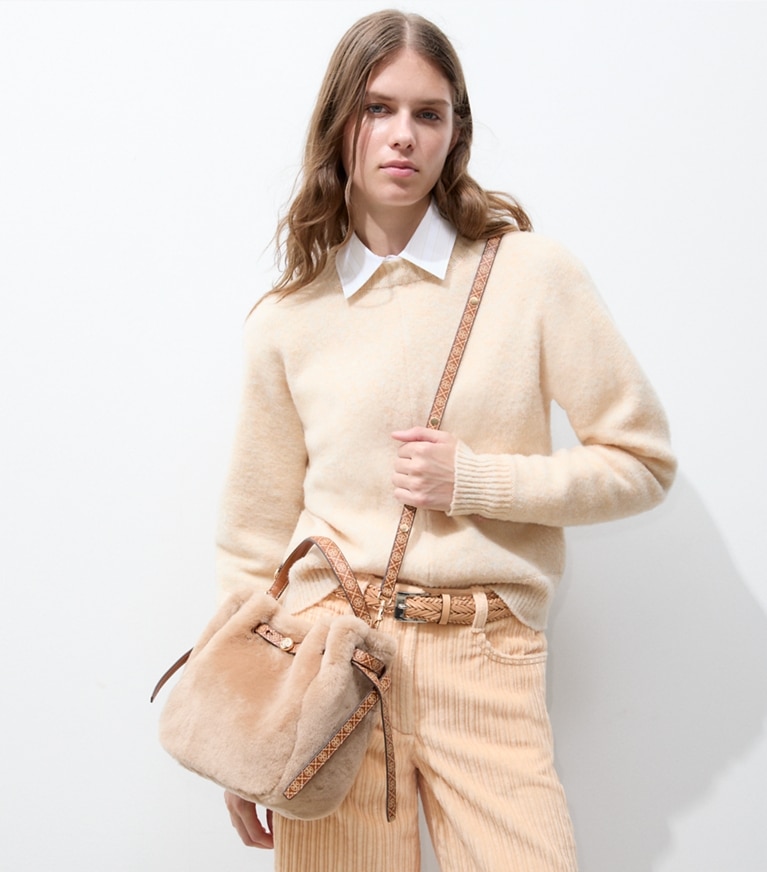 Tory Burch designer crossbody bags Romy Shearling Bucket Bag in Teddy additional on model