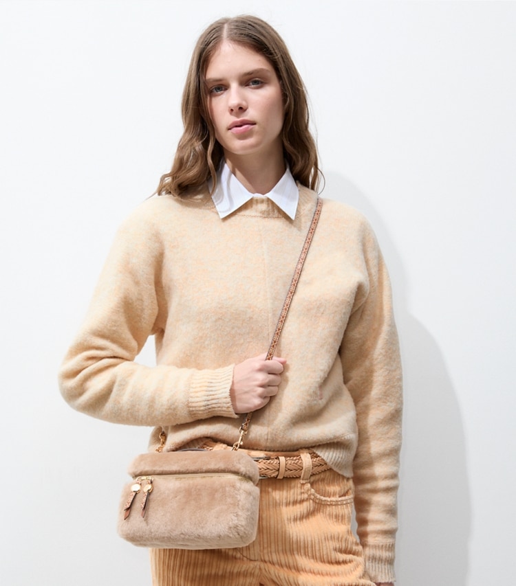 Tory Burch designer crossbody bags Romy Shearling Slim Top Handle Bag in Teddy accessory on model