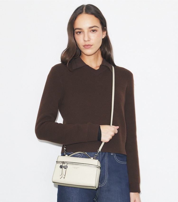 Tory Burch designer crossbody bags Romy Slim Top Handle Bag in Light Cream accessory on model