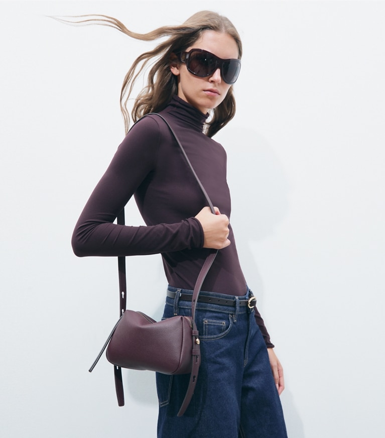 Tory Burch designer crossbody bags Romy Soft Crossbody Bag in Dark Carmine accessory on model