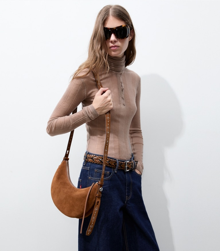 Tory Burch designer shoulder bags Romy Studded Suede Half Moon Bag in Caramel additional on model