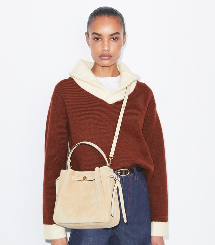 Tory Burch designer crossbody bags Romy Suede Pick Stitch Bucket Bag in Butter accessory on model