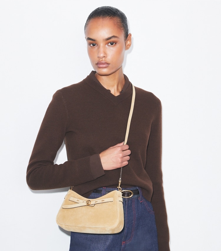 Tory Burch designer crossbody bags Romy Suede Zip Top Crossbody Bag in Butter accessory on model