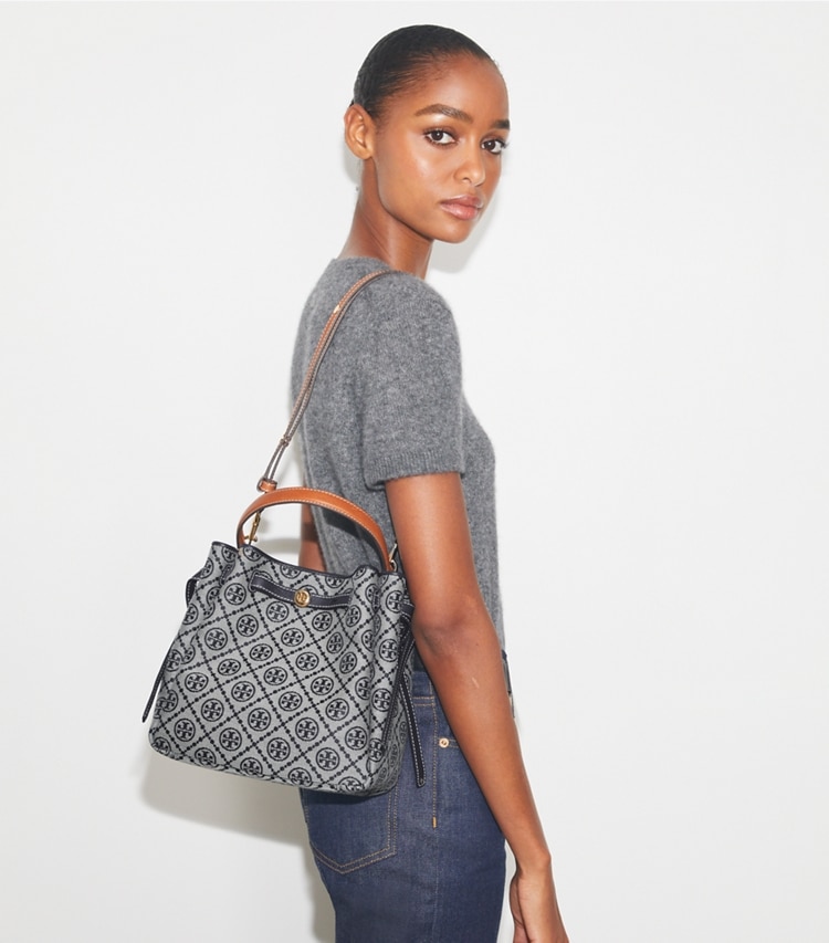Tory Burch designer crossbody bags Romy T Monogram Bucket Bag in Tory Navy accessory on model