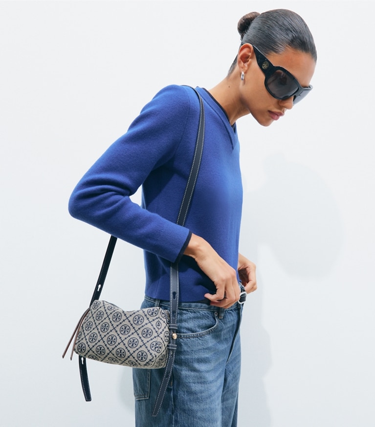 Tory Burch designer crossbody bags Romy T Monogram Soft Crossbody Bag in Tory Navy accessory on model