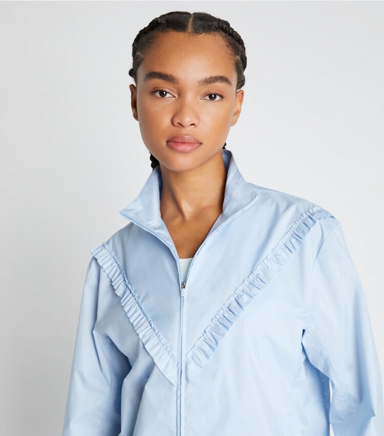 Tory Sport designer jackets Ruffle Windbreaker in Ice Flow on model detail