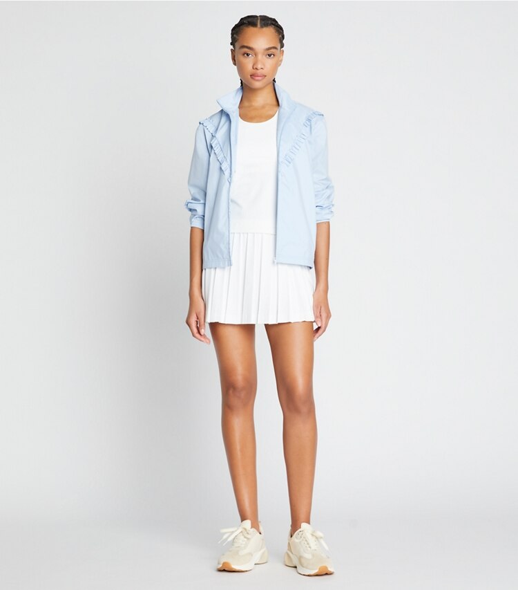 Tory Sport designer jackets Ruffle Windbreaker in Ice Flow on model front