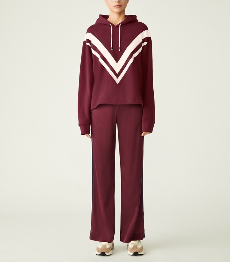 Tory Sport designer bottoms Satin Track Pant in Winetasting / Tory Navy on model front