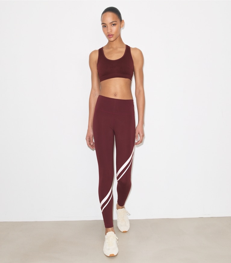 Tory Burch designer bottoms Sculpt Compression Diagonal Chevron Legging in Winetasting on model front