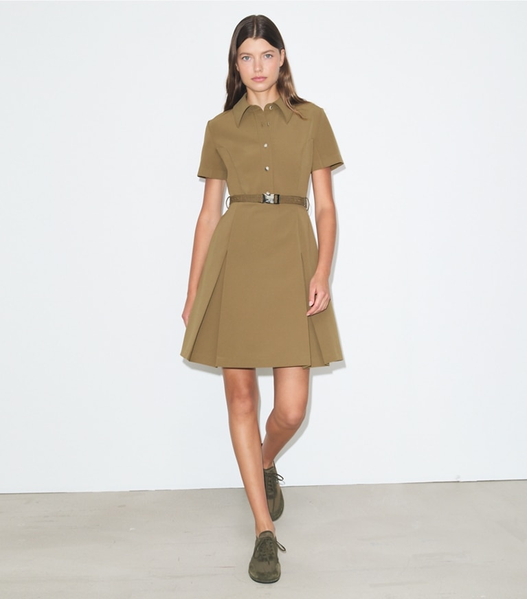 Tory Burch designer dresses Short-Sleeve Pleated Golf Dress in Olive on model front