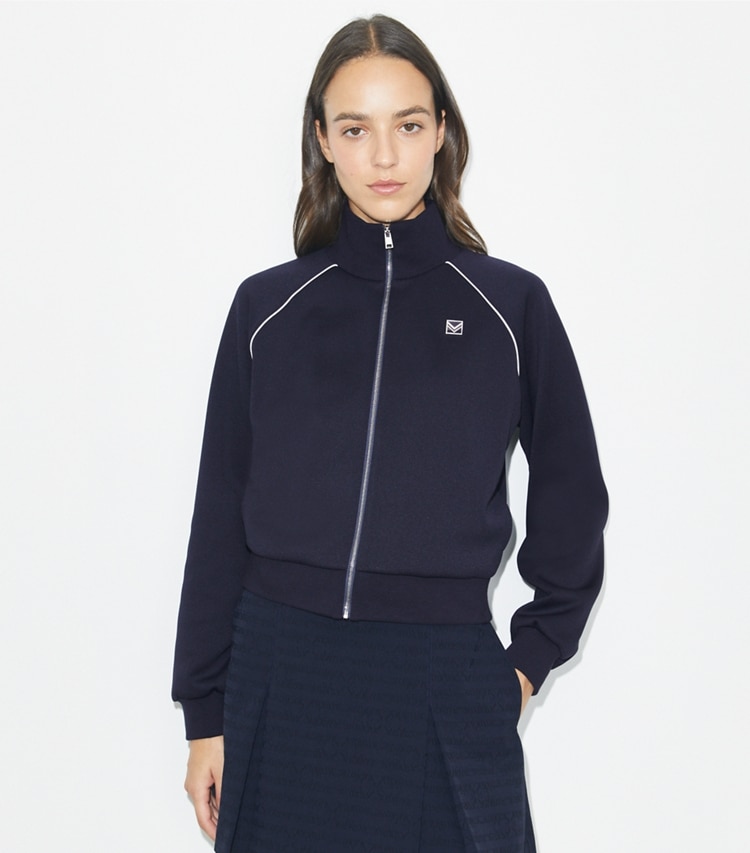 Tory Burch designer jackets Shrunken Raglan Track Jacket in Medium Navy on model detail