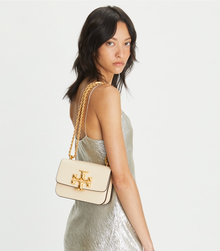 https://s7.toryburch.com/is/image/ToryBurch/style/small-eleanor-bag-accessory-on-model.TB_73589_122_20230410_OMACC.pdp-750x853.jpg