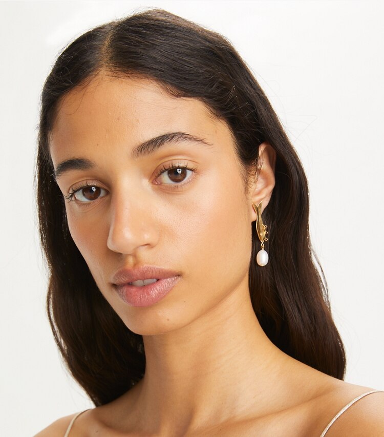 Tory Burch designer earrings Small Fish Earring in Rolled Light Brass / Ivory accessory on model