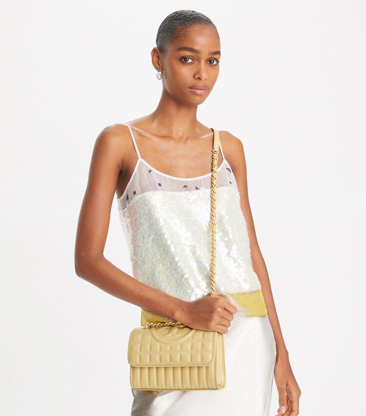 Tory Burch designer shoulder bags Small Fleming Patent Square Quilt Convertible Shoulder Bag in Vanilla Soft Serve additional on model