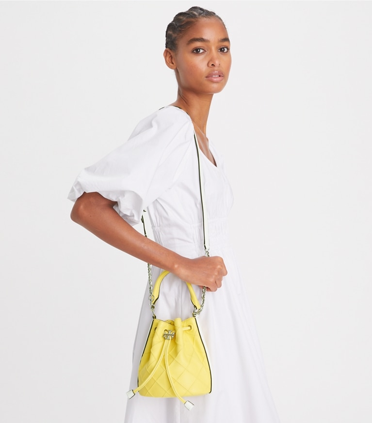 Tory Burch designer crossbody bags Small Fleming Soft Patent Border Bucket Bag in Vintage Lemon / Optic White angle