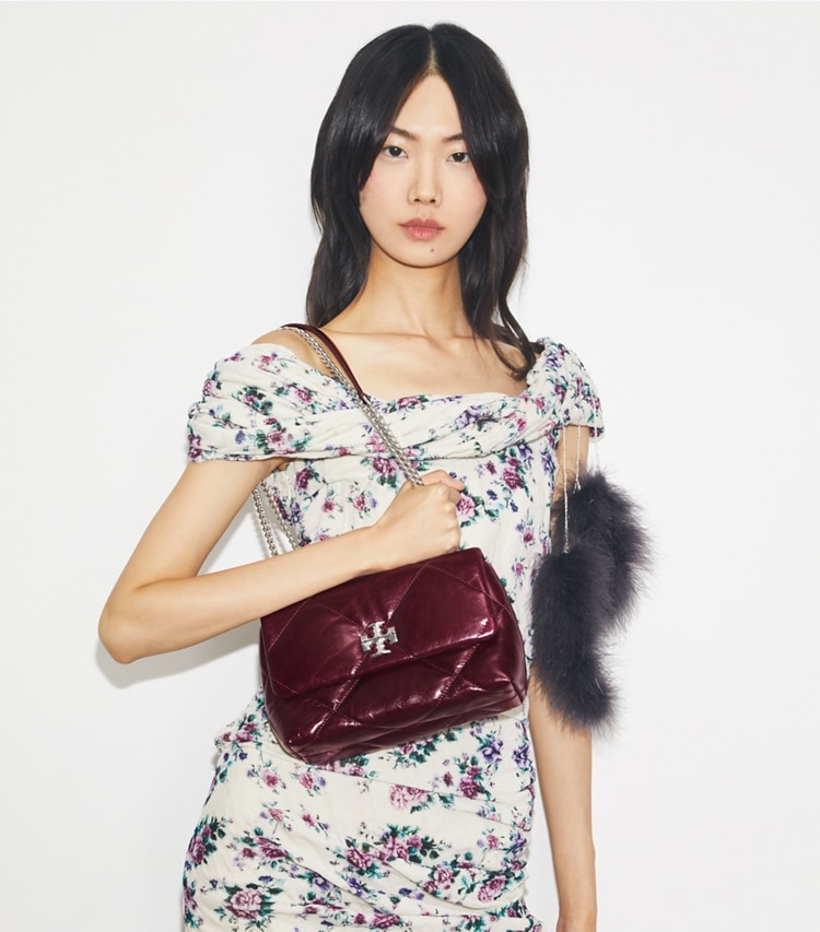 Tory Burch designer shoulder bags Small Kira Diamond Quilt Distressed Shoulder Bag in Dark Carmine accessory on model