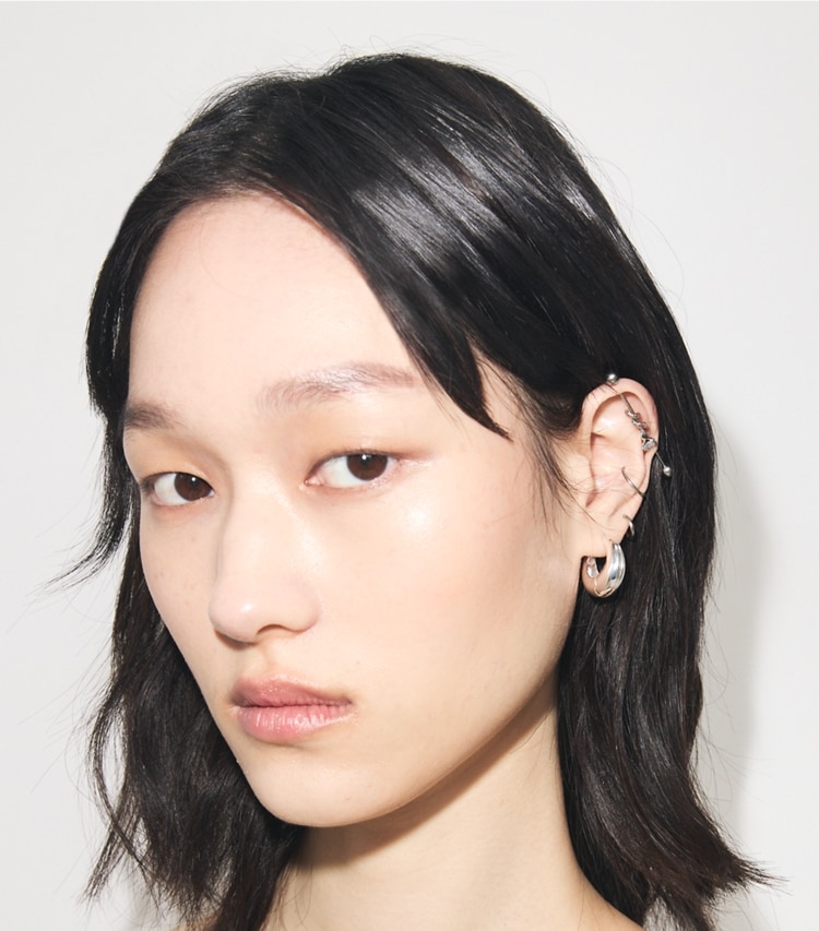 Tory Burch designer earrings Small Pierced Hoop Earrings in Light Silver accessory on model