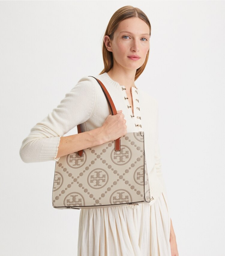 Tory Burch designer tote bags Small T Monogram Contrast Embossed Tote in LONGAN / New Cream accessory on model