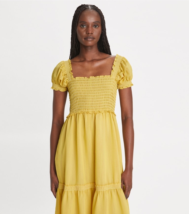 https://s7.toryburch.com/is/image/ToryBurch/style/smocked-silk-and-viscose-dress-on-model-detail.TB_157014_701_20231010_OMDET.pdp-767x872.jpg