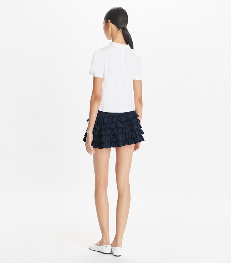Tory Sport designer bottoms Stretch Mini Tennis Skirt in Deep Navy on model back