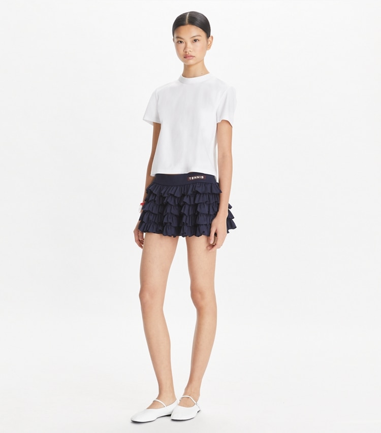 Tory Sport designer bottoms Stretch Mini Tennis Skirt in Deep Navy on model front