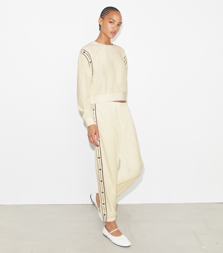Tory Burch designer bottoms T Logo Velour Jogger in New Ivory on model front