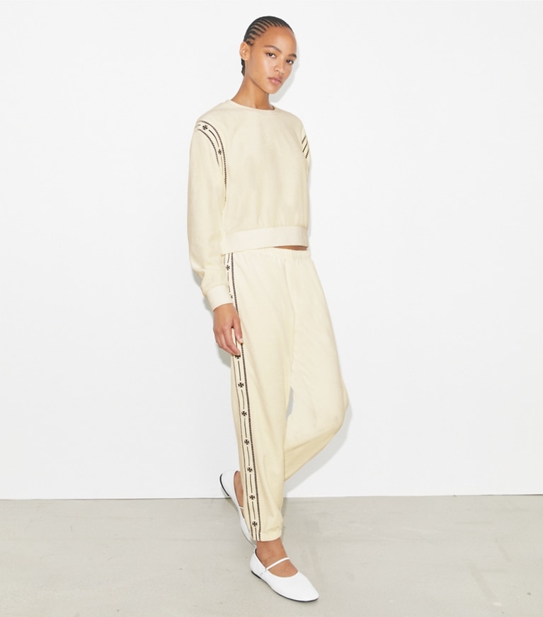 Tory Burch designer bottoms T Logo Velour Jogger in New Ivory on model front