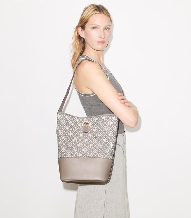 Tory Burch designer shoulder bags T Monogram Coated Jacquard Lock Slim Bucket Bag in Charcoal accessory on model