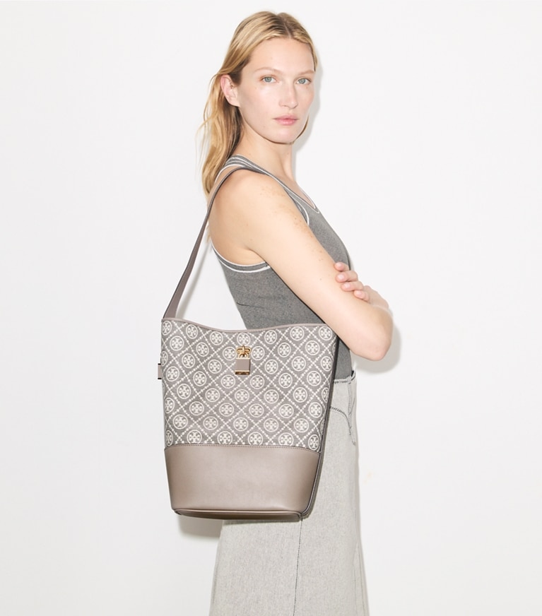 Tory Burch designer shoulder bags T Monogram Coated Jacquard Lock Slim Bucket Bag in Charcoal accessory on model