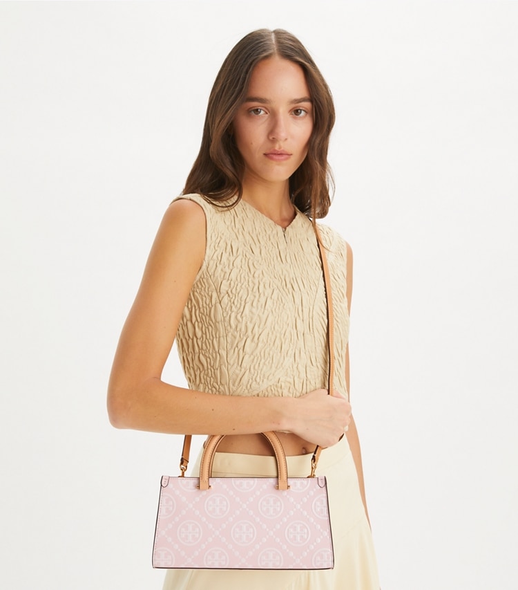Tory Burch designer satchels T Monogram Contrast Embossed Small East-West Tote in Powder Pink accessory on model