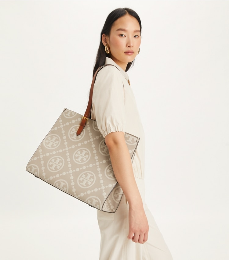 Tory Burch designer tote bags T Monogram Contrast Embossed Tote in LONGAN / New Cream accessory on model