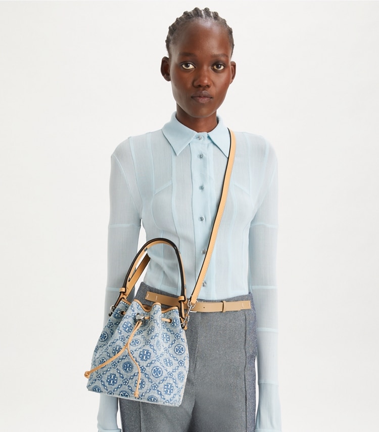 Tory Burch designer crossbody bags T Monogram Denim Bucket Bag in Powder Blue accessory on model