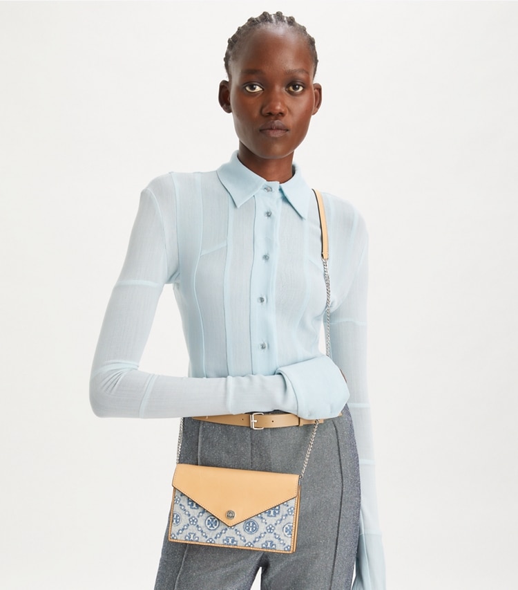 Tory Burch designer mini bags T Monogram Denim Envelope Crossbody in Seltzer accessory on model