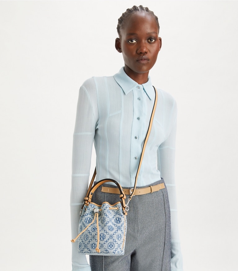 Tory Burch designer crossbody bags T Monogram Denim Mini Bucket Bag in Powder Blue angle