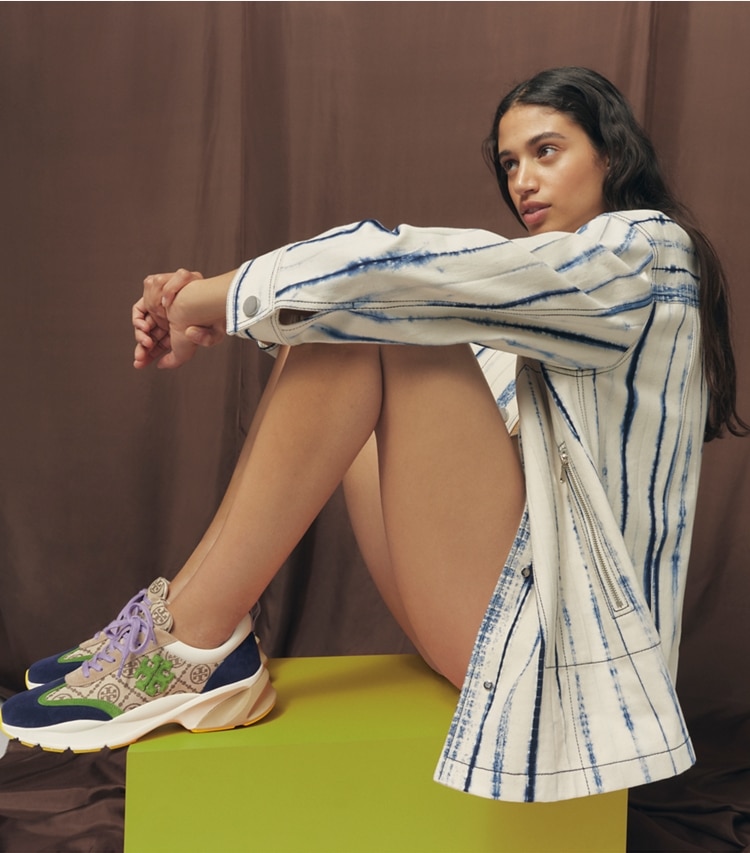 Tory Burch designer sneakers T Monogram Good Luck Trainer in Hazel T Monogram / SHISO / PERFECT NAVY accessory on model