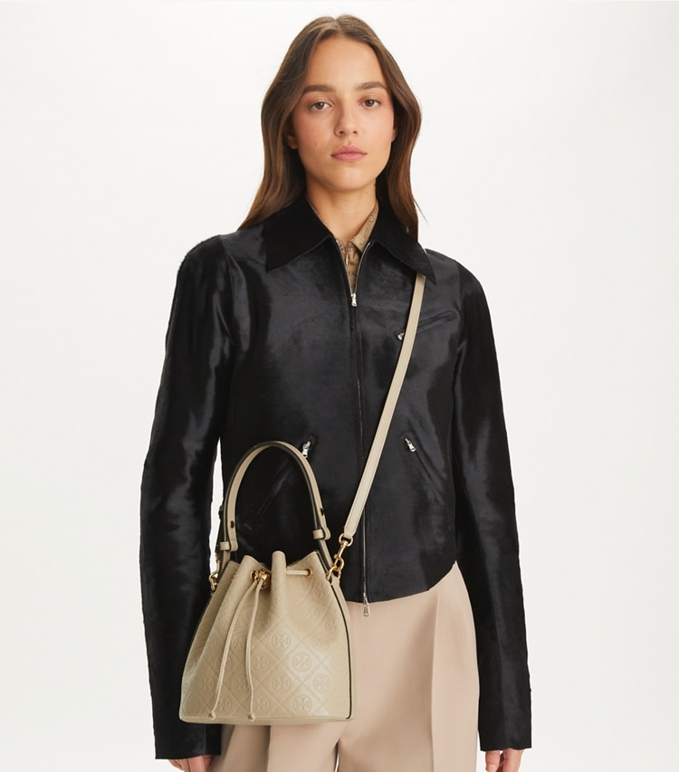 Tory Burch designer crossbody bags T Monogram Leather Bucket Bag in Fresh Clay accessory on model