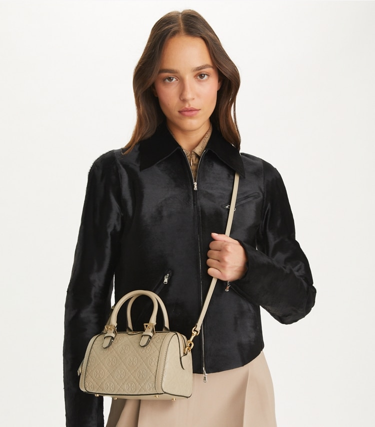 Tory Burch designer crossbody bags T Monogram Leather Petite Barrel Bag in Fresh Clay accessory on model