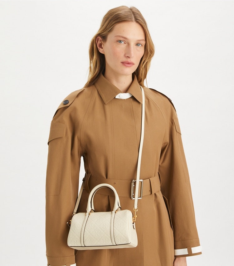 Tory Burch designer crossbody bags T Monogram Leather Petite Barrel Bag in Light Cream accessory on model