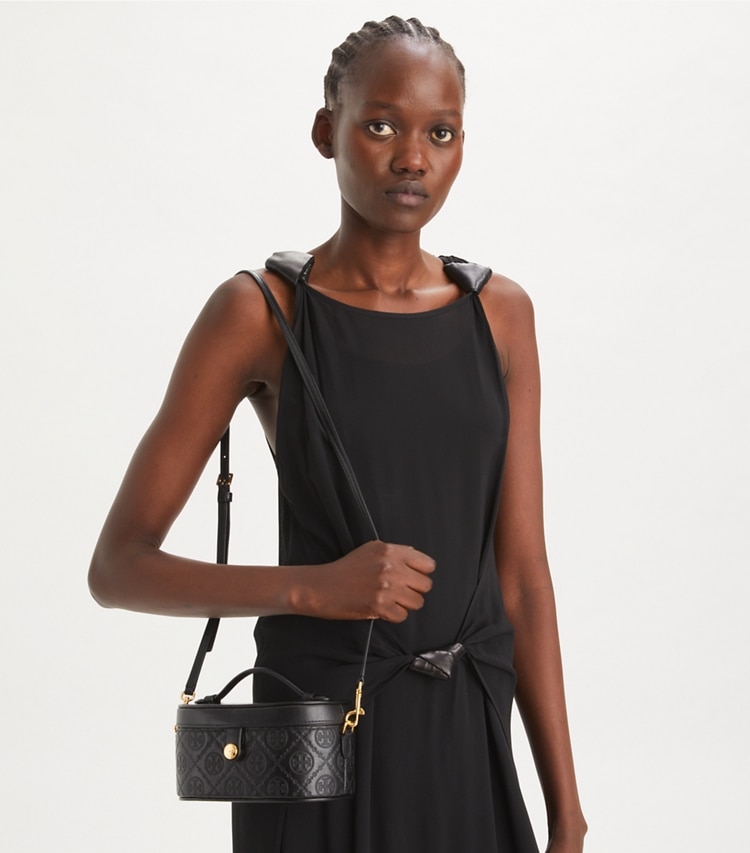 Tory Burch designer mini bags T Monogram Leather Vanity Case in Black accessory on model