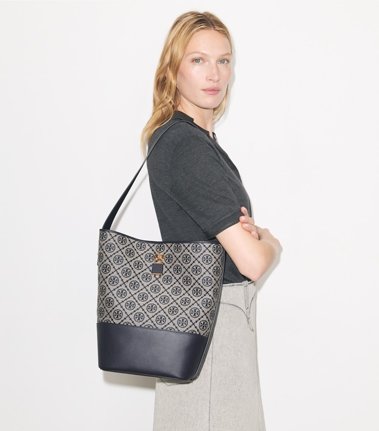 Tory Burch designer shoulder bags T Monogram Lock Slim Bucket Bag in Tory Navy accessory on model