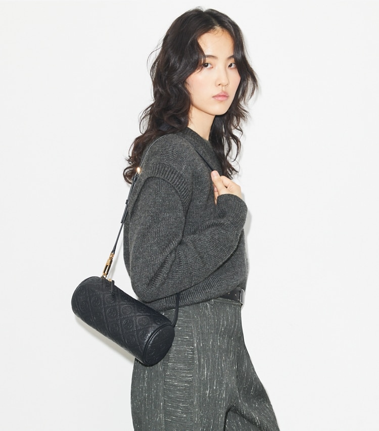 Tory Burch designer crossbody bags T Monogram Pebbled Cylinder Bag in Black accessory on model