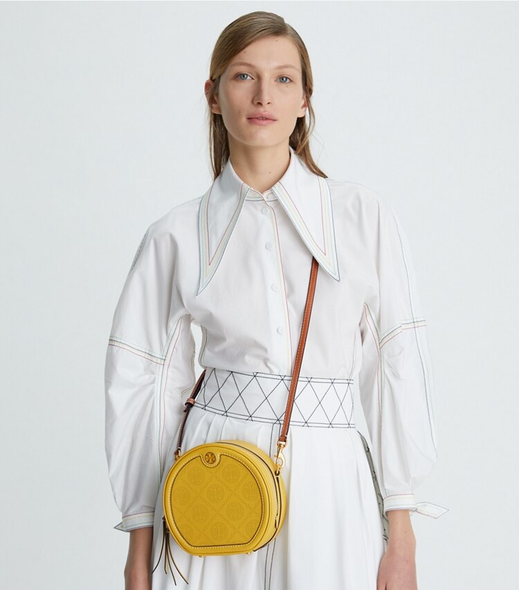 Tory Burch designer crossbody bags T Monogram Perforated Moon in Golden Sunset accessory on model