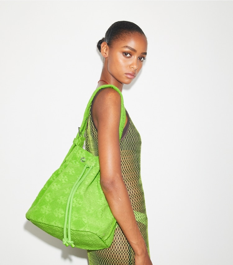 Tory Burch designer hobo bags T Monogram Terry Oversized Bucket Bag in Bright Fern accessory on model