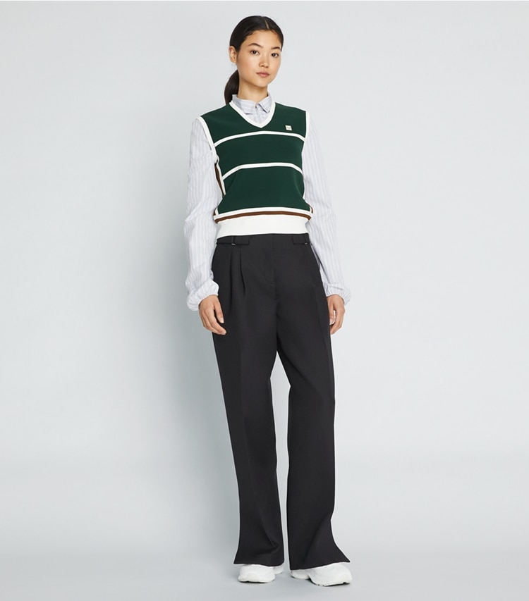 Tory Sport designer sweaters Tech Nylon Sweater Vest in Conifer on model front