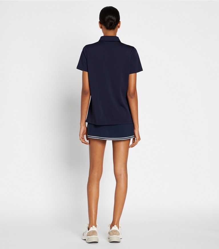 Tory Sport designer tops Tech Piqué Ruffle Polo in Tory Navy on model back