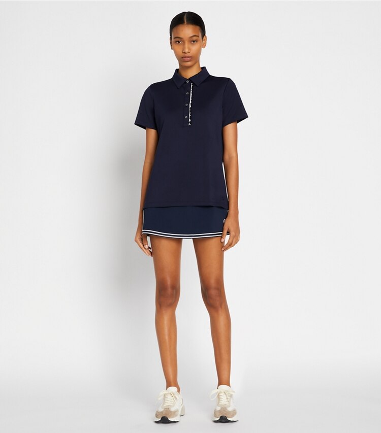 Tory Sport designer tops Tech Piqué Ruffle Polo in Tory Navy on model front